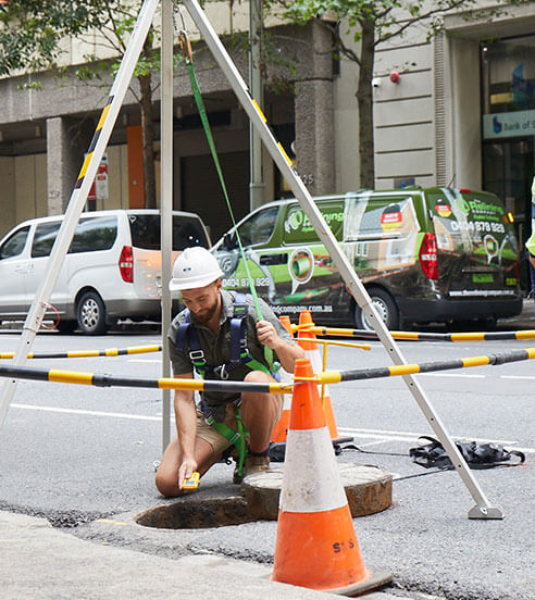 A Relining Company employee navigating a city sewer