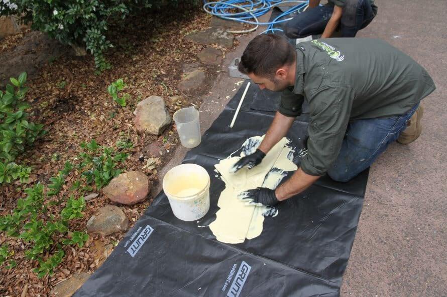 a pipe relining employee spreading pipe sealer