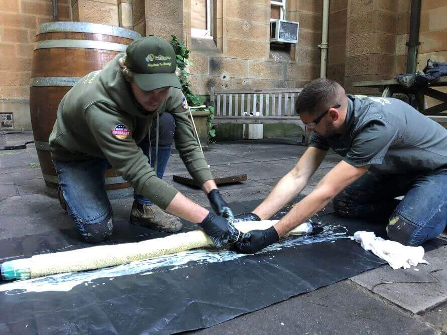 Two Pipe Relining employees fixing a drain