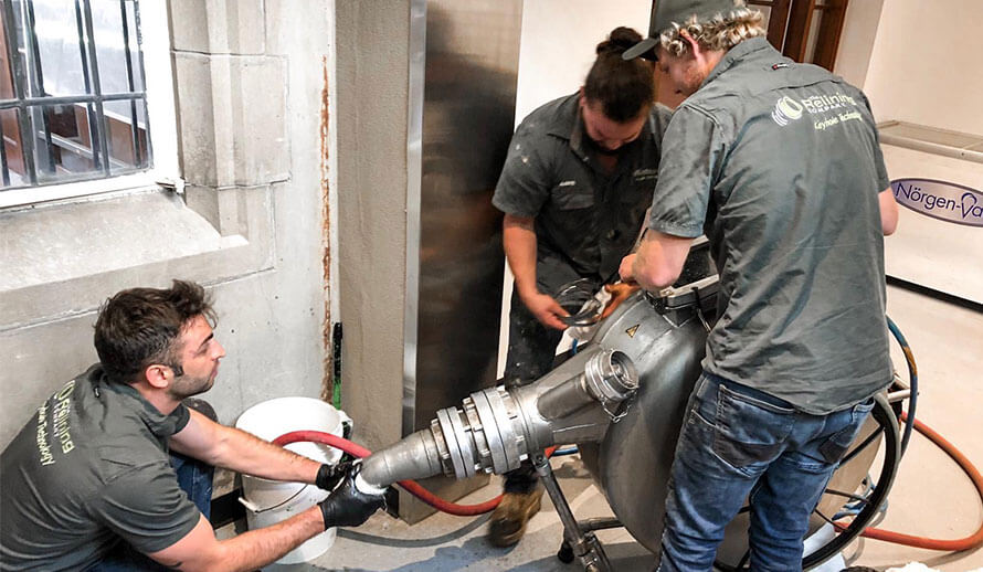 Pipe Relining employees fixing a drain indoors