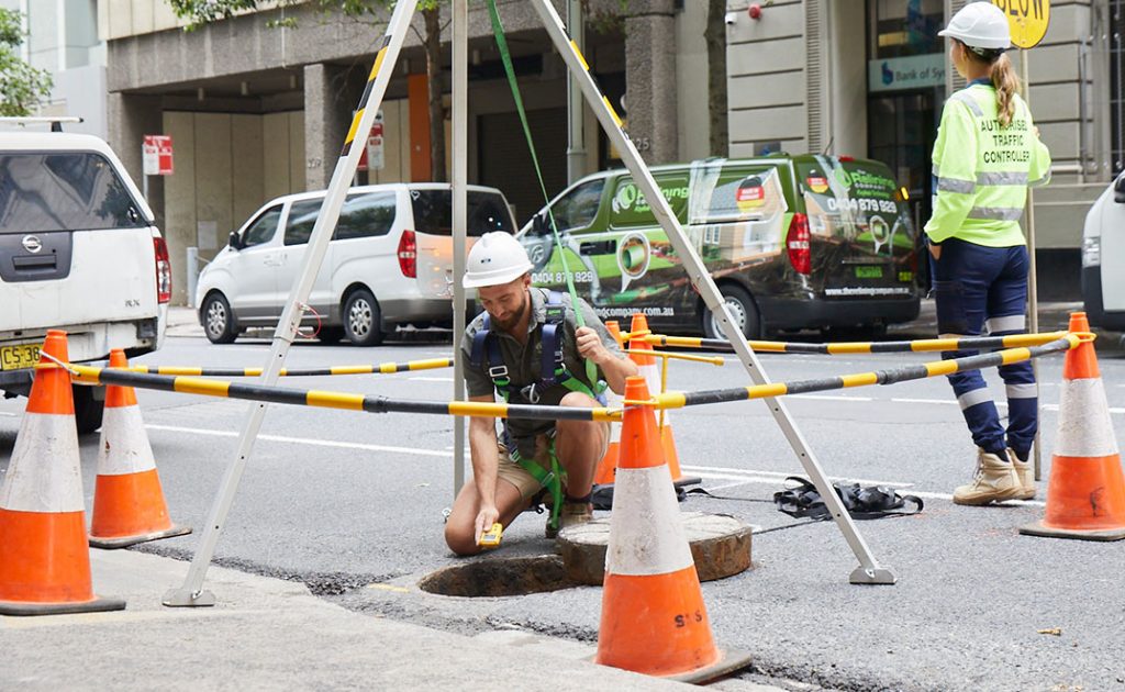 Pipe Relining Employee working on a city street sewer