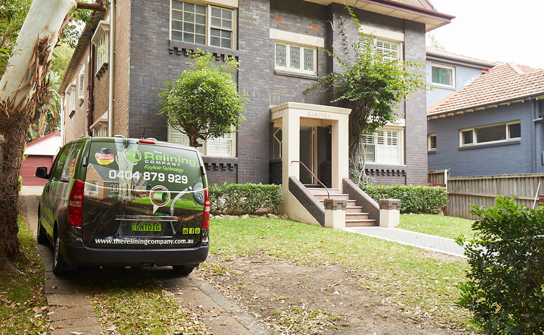 The Relining Company Van in front of a Brick Building