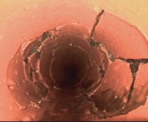 The cracked inside of a pipe