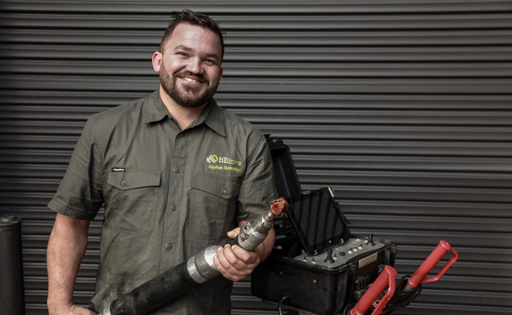 The Relining Company employee holding a robotic pipe cutter