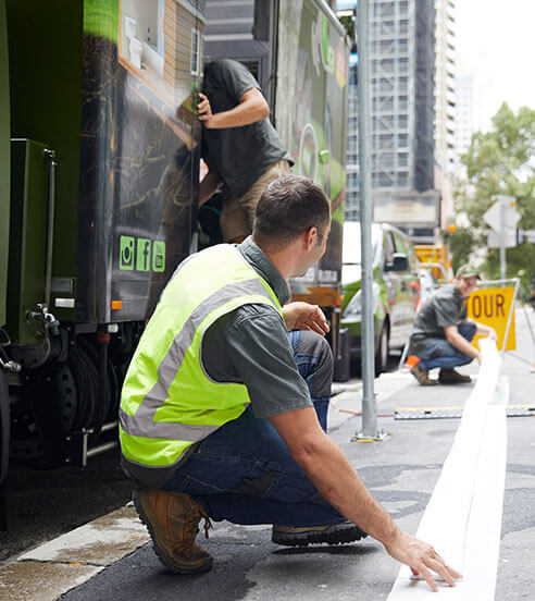 Two pipe relining employees taping down a line outside