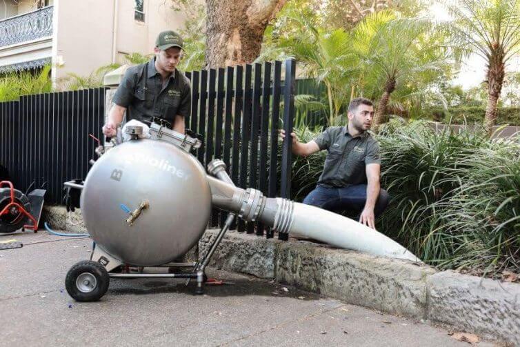 Two pipe relining specialists fixing stormwater drain