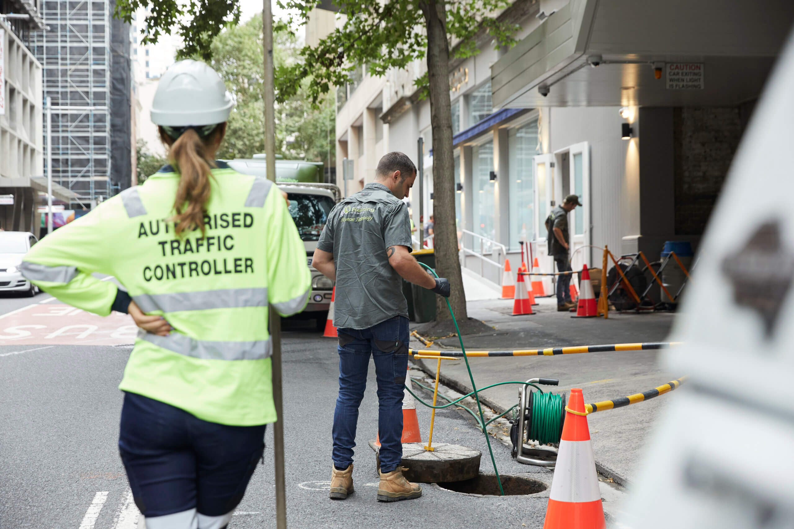 Employee working on sewage on side of the road
